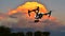 DRONE In Flight - Professional Camera (UAV / UAS) at Sunset