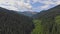 Drone fly above in the clouds over mountains in summer. Mountain panorama carpathian mountains meadows.