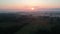 Drone fly above Summer time sunrise and mist in farmland