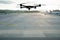 drone flying above the airport runway