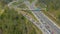 DRONE: Flying above a busy highway network during peak rush hour in the summer.