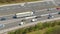 DRONE: Flying above a cargo truck carrying heavy freight through a traffic jam.