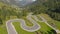 DRONE: Flying above motorbikers and cyclists riding down a winding mountain road