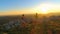 DRONE Flying behind sporty tourist couple running along mountain trail at sunset