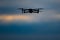 Drone flying on dark evening or night sky