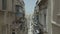 Drone flying forward on narrow beautiful old street,Valletta,Malta . Old, vintage windows, balconies. - 4K