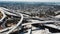 Drone flying left high above big Judge Pregerson freeway junction in Los Angeles with multiple bridges and flyovers.