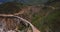 Drone flying over amazing famous Bixby Canyon Bridge and Highway 1 sunny summer landscape scenery in Big Sur California.