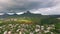 Drone flying over the Belle Etoile town in Mauritius, close to Port Louis. Stormy Sky and mountain in Background