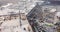 Drone flying over the construction site of a shopping center with construction equipment and workers