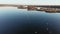 Drone flying over the estuary of a river. On the bank there are dry reeds.