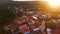 Drone flying over the green hills and beautiful buildings in Sighnaghi at sunset