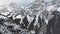 Drone flying over the snowy wooded hill towards the white rocks in the haze in winter in Kananaskis, Alberta, Canada