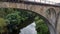 Drone flying under ancient roman viaduct