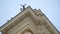 Drone flying upwards near an old architectural building