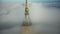 Drone flying very close to epic golden castle spire top of Mont Saint Michel, iconic cloudy fortress island in Normandy.