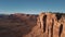 Drone flying very high near massive American desert mountain ridge, epic sunny canyon cliffs skyline in the background.