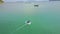 Drone Follows Fisherman Sailing on Round Boat with Engine
