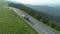 Drone follows large transportation truck down a mountain road