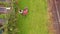 Drone footage of gardener pushing wheelbarrow