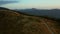 Drone green mountain path view with amazing spruces growing agains sunset sky