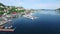 Drone, harbor and boat in ocean with nature, scenery and landscape background for location or holiday. Aerial view