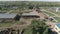 Drone from a height flies around a grain dryer on an agricultural farmstead