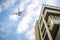 Drone with high resolution digital camera flying over city . An aerial view of a flying multi-copter with raised landing gears and