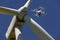 Drone hovering over wind turbines, renewable energy