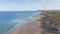 drone hyperlapse flying over Bude beach and ocean clouds shadow and sun rays in Devon