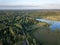 drone image. country lake surrounded by pine forest and fields f