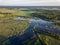 drone image. country lake surrounded by pine forest and fields f