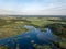 drone image. country lake surrounded by pine forest and fields f