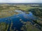 drone image. country lake surrounded by pine forest and fields f