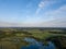 drone image. country lake surrounded by pine forest and fields f