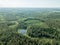 drone image. country lake surrounded by pine forest and fields f