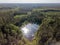 drone image. country lake surrounded by pine forest and fields f