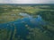 drone image. country lake surrounded by pine forest and fields f