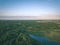 drone image. country lake surrounded by pine forest and fields f
