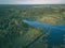 drone image. country lake surrounded by pine forest and fields f