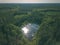 drone image. country lake surrounded by pine forest and fields f