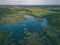 drone image. country lake surrounded by pine forest and fields f