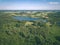 drone image. country lake surrounded by pine forest and fields f