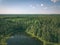 drone image. country lake surrounded by pine forest and fields f