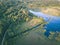 drone image. country lake surrounded by pine forest and fields f