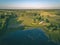 drone image. country lake surrounded by pine forest and fields f