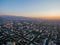 Drone Image Over City at Sunset With Mountains