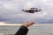 Drone landing on hand at Baltic Sea