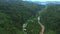 Drone, landscape and valley with road in forest for environment, countryside wildernesses and trees. Travel, river and