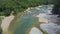 Drone Lows down and Flies above Rocky River among Jungle